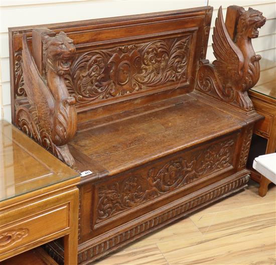 A Renaissance style carved oak box seat monks bench W.120cm